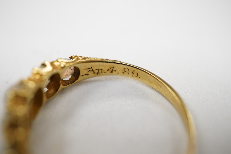 A late Victorian yellow metal and five stone graduated white opal set half hoop ring, the inner shank engraved 'Bran? Ap 4.89', size L.